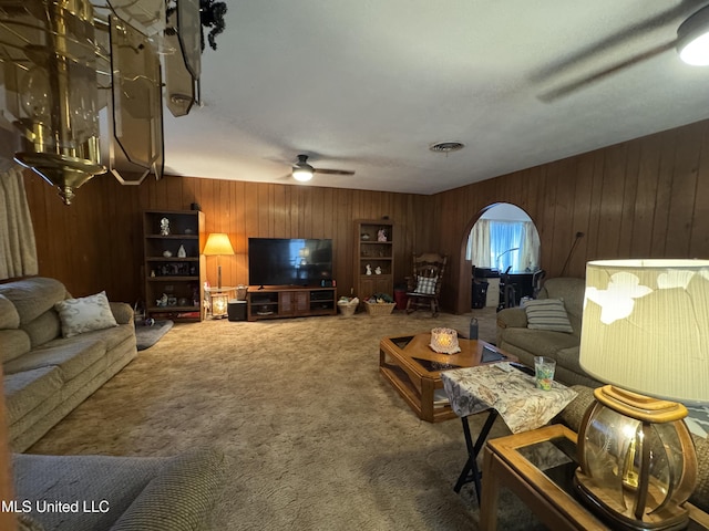 15708 Orleans Dr, Biloxi, MS 39532 - carpeted living area featuring wooden walls and a ceiling fan