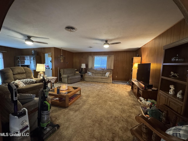 15708 Orleans Dr, Biloxi, MS 39532 - carpeted living area featuring a ceiling fan and wood walls
