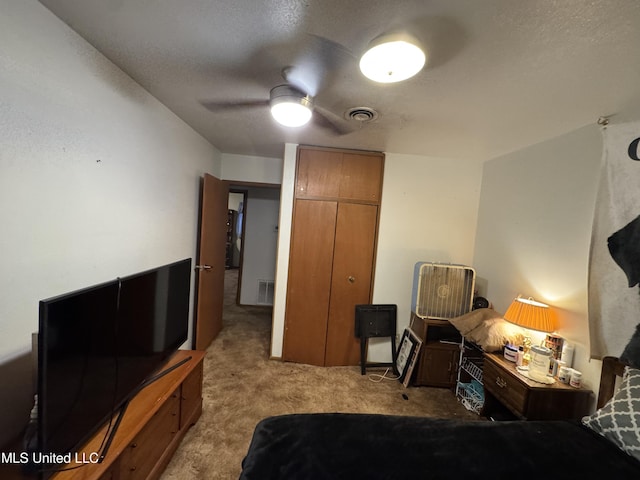 15708 Orleans Dr, Biloxi, MS 39532 - bedroom with carpet, a closet, a textured ceiling, and ceiling fan