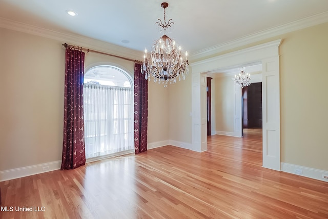 unfurnished room with light hardwood / wood-style floors, an inviting chandelier, and ornamental molding