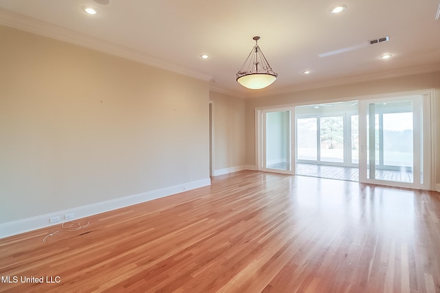 empty room with light hardwood / wood-style floors and ornamental molding