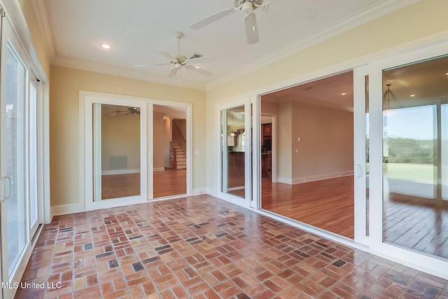 unfurnished sunroom with ceiling fan