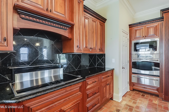 kitchen with tasteful backsplash, dark stone countertops, stainless steel appliances, and ornamental molding