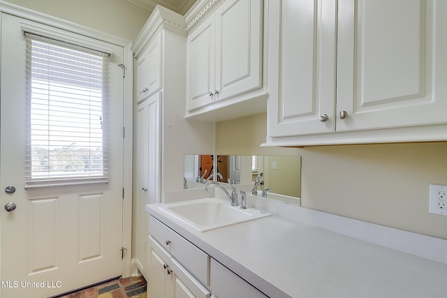 clothes washing area featuring sink