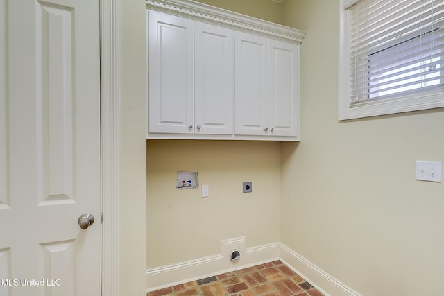 clothes washing area featuring hookup for an electric dryer, washer hookup, and cabinets