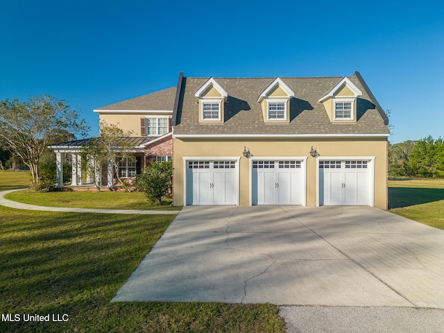 view of front facade with a garage and a front lawn