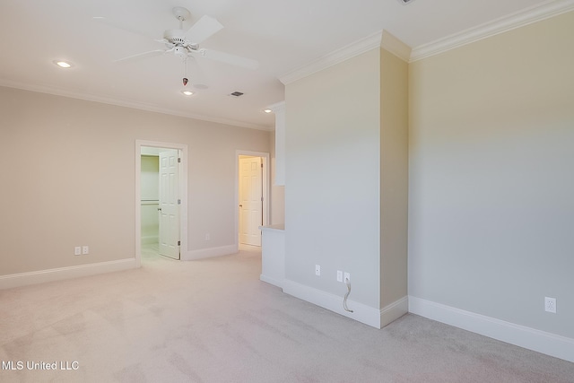 carpeted spare room with ceiling fan and crown molding