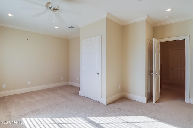 unfurnished bedroom with light colored carpet, ceiling fan, and crown molding