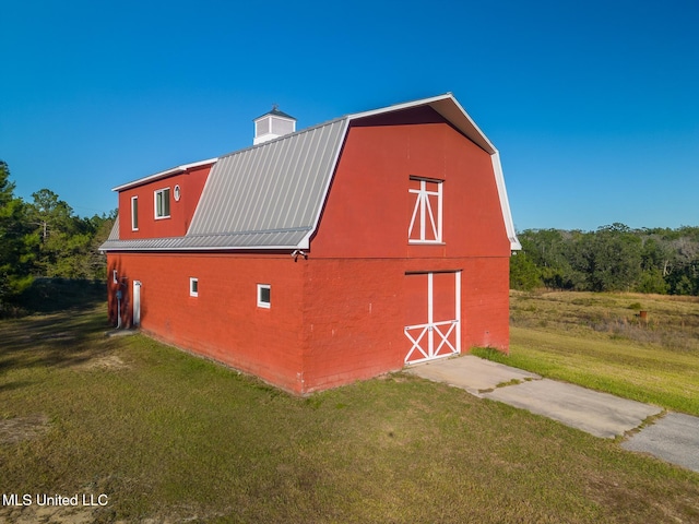 view of outbuilding with a yard