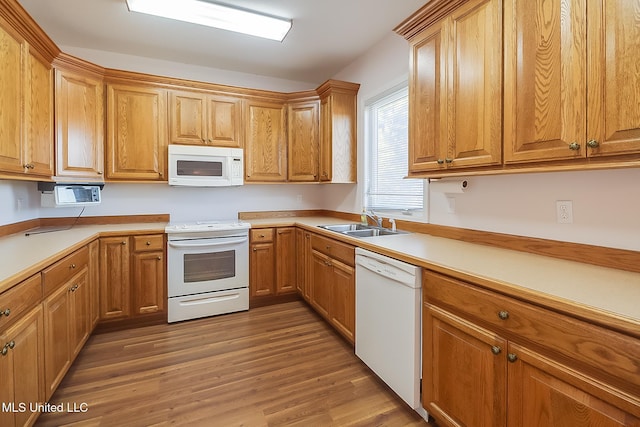 kitchen featuring sink, dark hardwood / wood-style floors, and white appliances