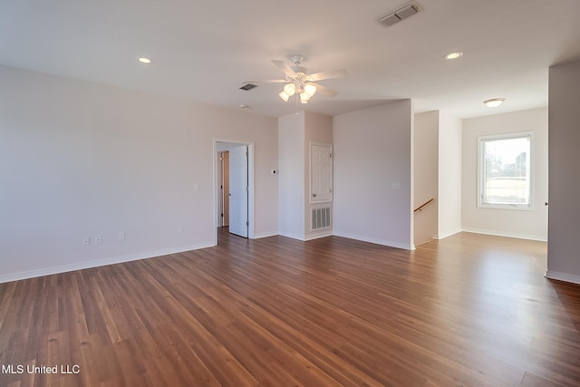 empty room with ceiling fan and dark hardwood / wood-style flooring