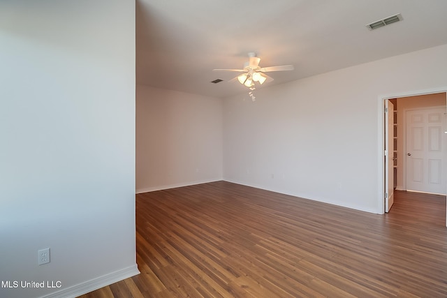 empty room with ceiling fan and dark wood-type flooring