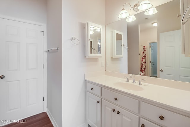 bathroom with hardwood / wood-style flooring, vanity, and a shower with curtain