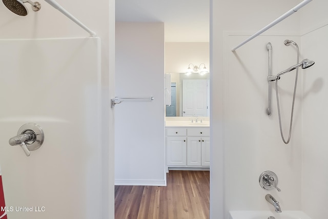 bathroom with vanity, tub / shower combination, and hardwood / wood-style flooring