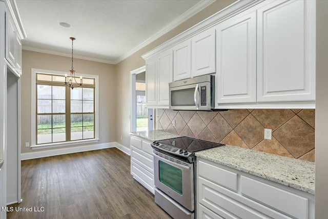 kitchen featuring stainless steel appliances, white cabinets, ornamental molding, and backsplash