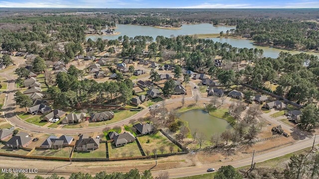 drone / aerial view featuring a water view and a residential view