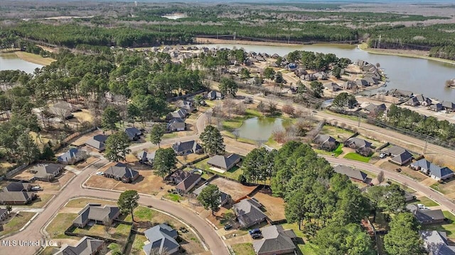 drone / aerial view featuring a water view and a residential view