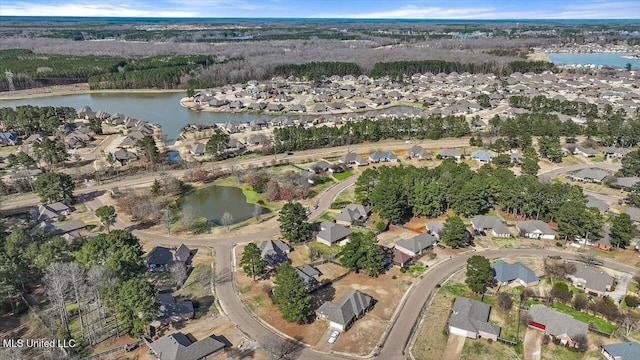 birds eye view of property with a water view and a residential view