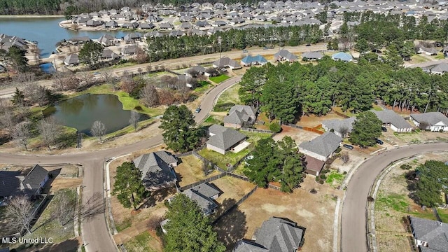 drone / aerial view with a residential view and a water view