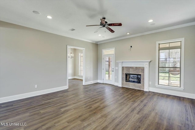 unfurnished living room with a fireplace, baseboards, and crown molding