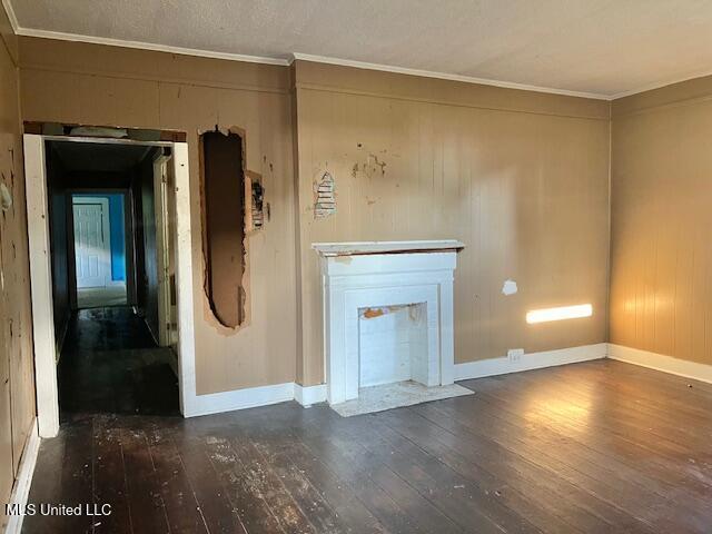 721 Adams St, Vicksburg, MS 39183 - unfurnished living room featuring wood-type flooring, ornamental molding, and baseboards