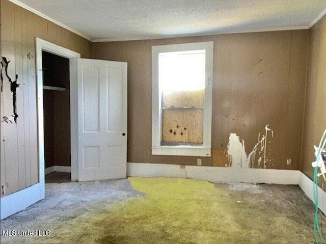 721 Adams St, Vicksburg, MS 39183 - unfurnished bedroom with carpet, ornamental molding, and wood walls