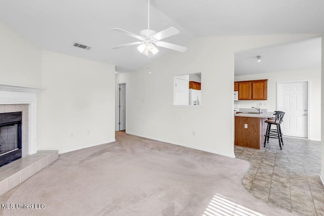 14196 Maple Ct, Gulfport, MS 39503 - unfurnished living room featuring a sink, a ceiling fan, a fireplace, baseboards, and high vaulted ceiling