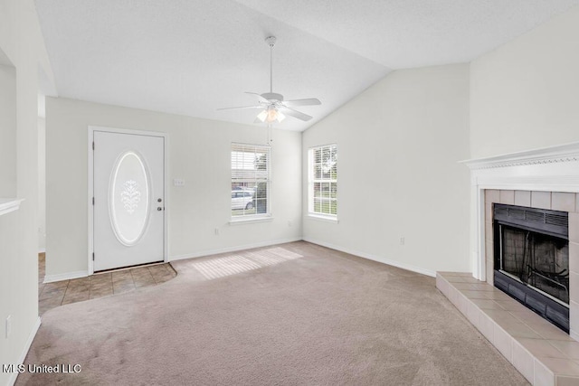 14196 Maple Ct, Gulfport, MS 39503 - unfurnished living room with carpet floors, ceiling fan, a fireplace, vaulted ceiling, and baseboards