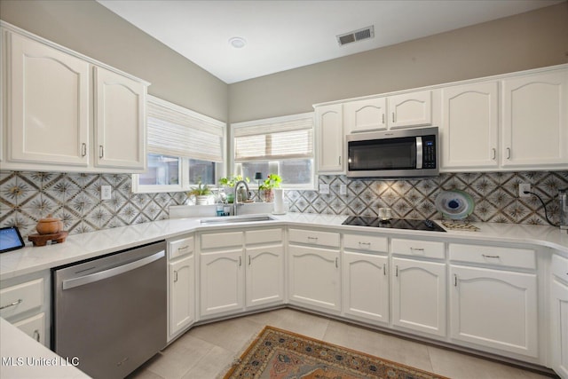 kitchen with white cabinetry, light tile patterned floors, and appliances with stainless steel finishes