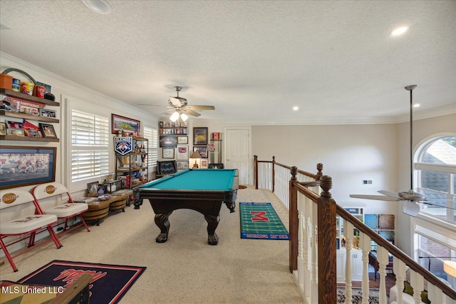 rec room featuring a textured ceiling, ornamental molding, carpet, billiards, and ceiling fan