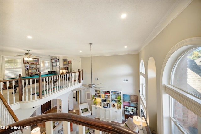 stairway featuring plenty of natural light and crown molding