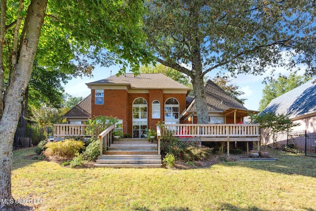 view of front facade with a front lawn and a deck