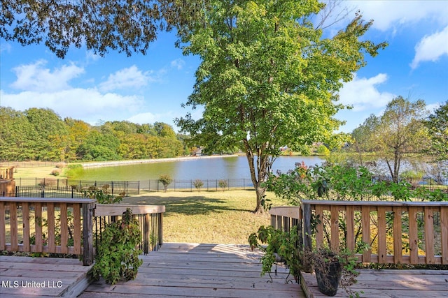 deck featuring a water view and a lawn