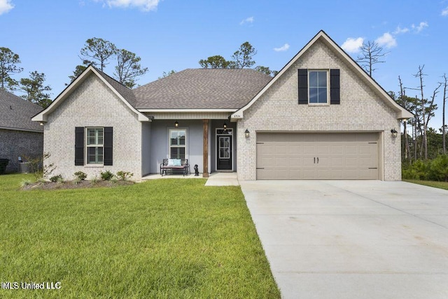 traditional-style home with brick siding, a shingled roof, an attached garage, driveway, and a front lawn