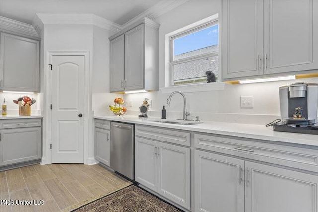 kitchen featuring gray cabinetry, a sink, light countertops, light wood-type flooring, and dishwasher