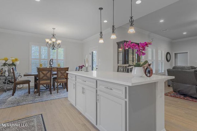 kitchen featuring light wood-style flooring, open floor plan, and light countertops