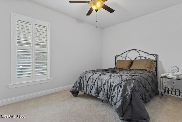 bedroom featuring carpet, baseboards, and a ceiling fan