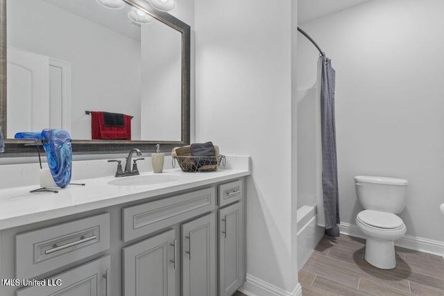 full bath featuring shower / tub combo, baseboards, toilet, vanity, and wood finish floors