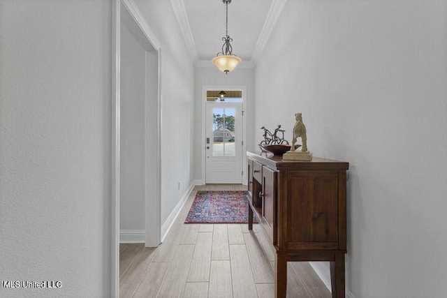 entryway with light wood finished floors, baseboards, and ornamental molding