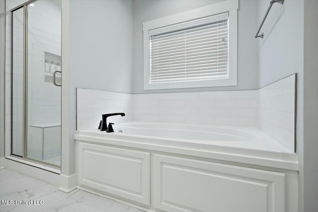 bathroom with shower with separate bathtub