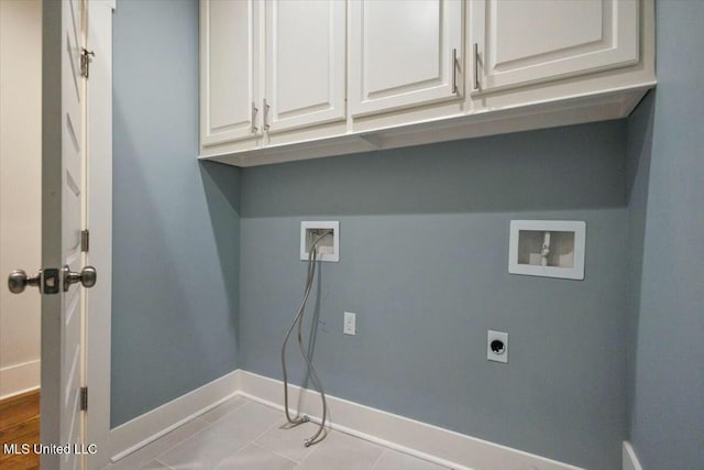 clothes washing area featuring cabinets, washer hookup, and hookup for an electric dryer