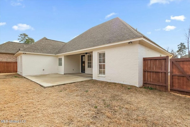 back of house with ceiling fan and a patio area