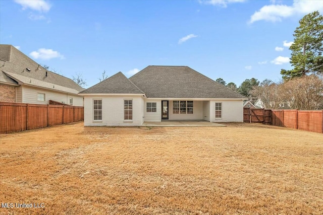 back of house featuring a yard and a patio