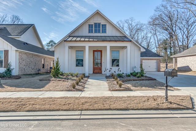 603 Cobalt Way, Brandon, MS 39042 - modern inspired farmhouse with a detached garage, driveway, board and batten siding, metal roof, and a standing seam roof