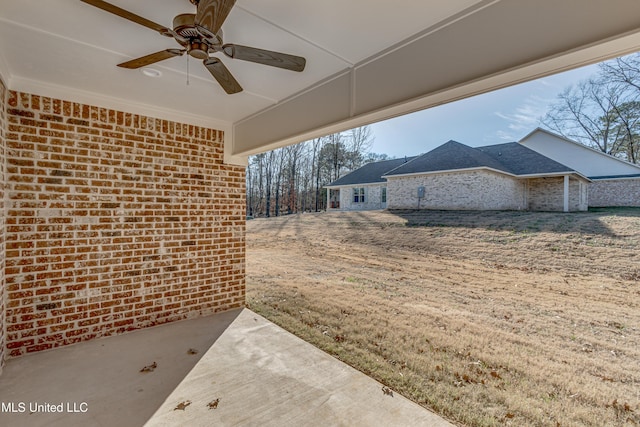 view of yard with ceiling fan and a patio area