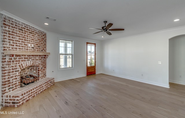 unfurnished living room featuring light hardwood / wood-style floors, ceiling fan, and ornamental molding