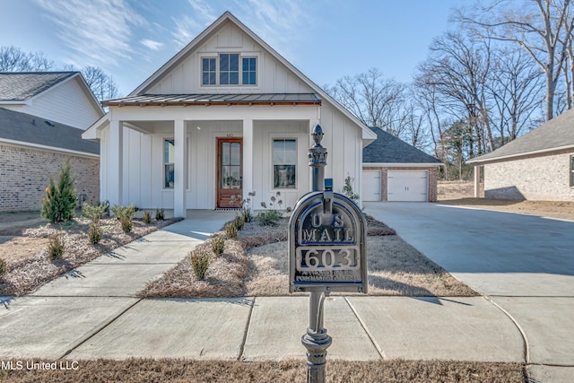 603 Cobalt Way, Brandon, MS 39042 - view of front of property with board and batten siding, metal roof, covered porch, a garage, and a standing seam roof