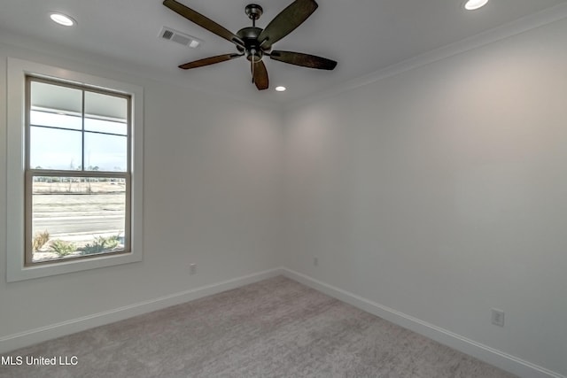 carpeted empty room with crown molding and ceiling fan