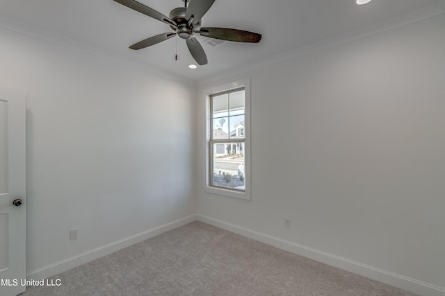 empty room featuring ceiling fan, light carpet, and ornamental molding