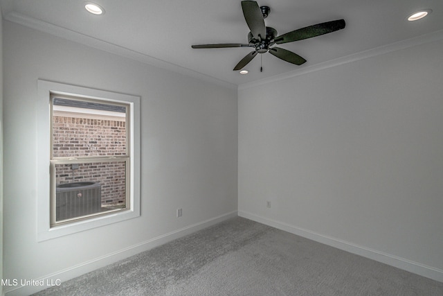 carpeted spare room with ceiling fan and ornamental molding